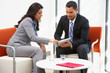 Businessman And Businesswoman Having Informal Office Meeting