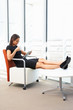 Photo: Businesswoman Relaxing With Digital Tablet During Break Businesswoman Relaxing With Digital Tablet During Break