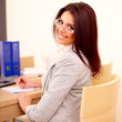 Young beautiful woman working in office. Making notes