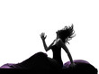woman happy awekening sitting in bed silhouette