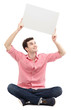 Photo: Young man holding blank poster Young man holding blank poster