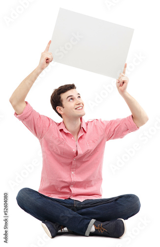 Photo: Young man holding blank poster Young man holding blank poster