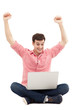 Photo: Man raising his arms in front of laptop Man raising his arms in front of laptop