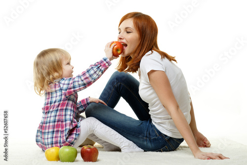Photo: Mother and child with apples. Mother and child with apples.