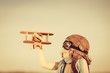 Happy kid playing with toy airplane