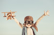 Happy kid playing with toy airplane