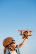 Happy kid playing with toy airplane