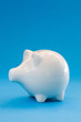 White Piggy Bank On Blue Background