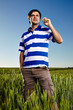 Photo: Young man standing in a wheat field Young man standing in a wheat field
