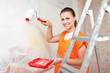  painter paints wall with roller