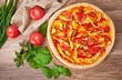 Appetizing pizza with chicken, tomatoes, peppers and cheese