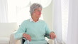 Mature Caucasian woman looking through window