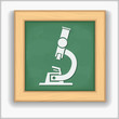 Blackboard with icon of a microscope