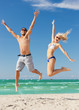 couple jumping on the beach