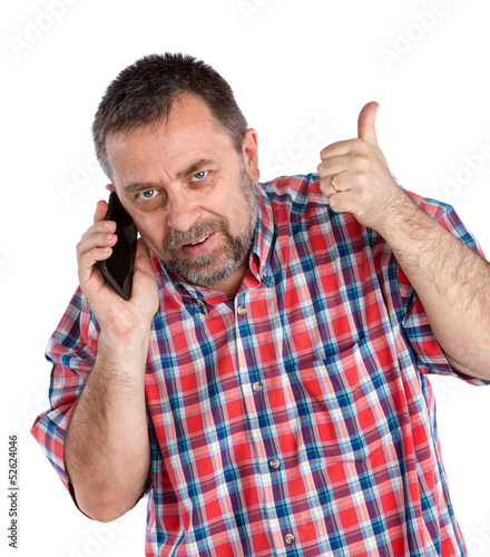 Photo: middle-aged man speaks on a mobile phone middle-aged man speaks on a mobile phone
