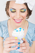 Pin-up girl with colorful makeup and manicure holding ice-cream