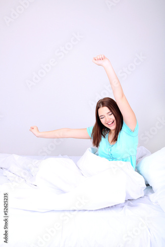 Leinwandbild Motiv Beautiful young woman in bed.