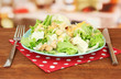 Caesar salad on blue plate, on bright background