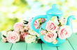 Pot with flowers on a wooden table on the nature background