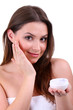 Woman applying lifting cream from container