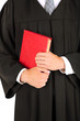 Young graduation man with book, close up