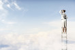 Photo: Businesswoman standing on ladder Businesswoman standing on ladder