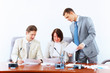 Three Businesspeople At Meeting