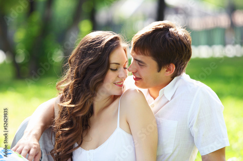 Photo: Young love Couple smiling under blue sky Young love Couple smiling under blue sky