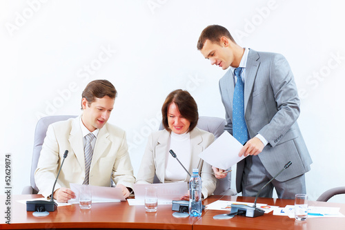 Photo: Three businesspeople at meeting Three businesspeople at meeting
