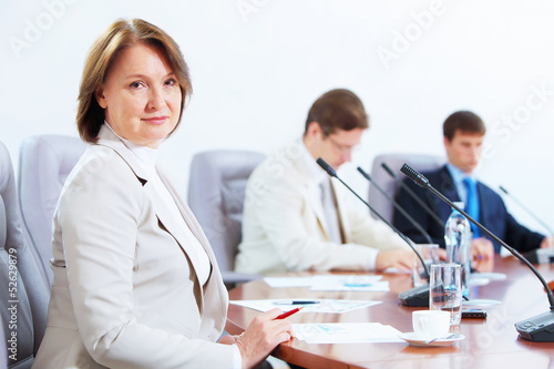 Photo: Three businesspeople at meeting Three businesspeople at meeting