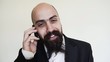 Funny bearded businessman on the phone