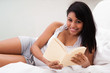 Happy Young Woman Reading Book