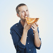 portrait of a young beautiful man eating a slice of pizza marghe
