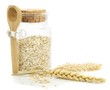 A jar of oatmeal flakes and wheat on a white background