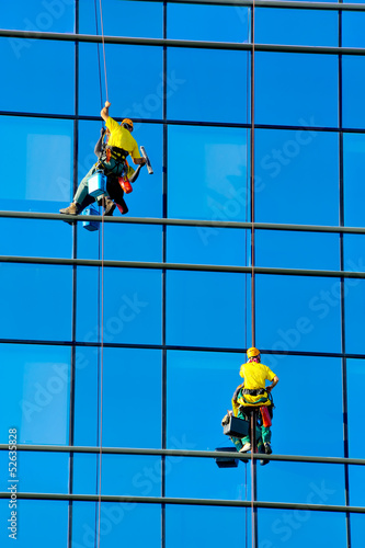 Photo: Washers wash the windows of modern skyscraper Washers wash the windows of modern skyscraper