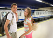Foto: Couple of tourists waiting to get in train Couple of tourists waiting to get in train