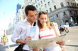 Couple of tourists in Gran Via avenue of Madrid