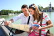Couple in Retiro Park of Madrid looking at map