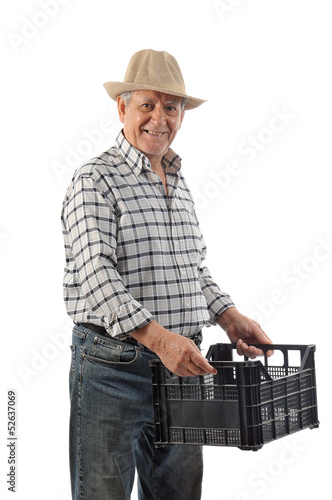 Photo: a man carries a plastic basket a man carries a plastic basket