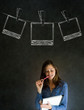 Businesswoman with chalk polaroid photos blackboard background