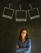 Businesswoman with chalk polaroid photos blackboard background