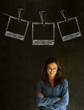 Businesswoman with chalk polaroid photos blackboard background