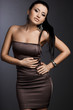 beautiful fashionable woman in brown dress