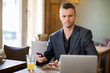 Young Business man With Mobilephone And Laptop In Coffeeshop