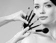 beautiful woman. Makeup brushes.