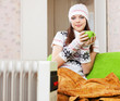  woman relaxing near oil heater