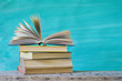 pile of books, one open, book arrangement, free copy space