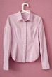 Stripy  blouse is on a hanger.