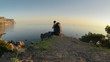 The girl tourist with backpack is traveling in the mountains