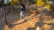 The girl tourist with backpack is traveling in the mountains